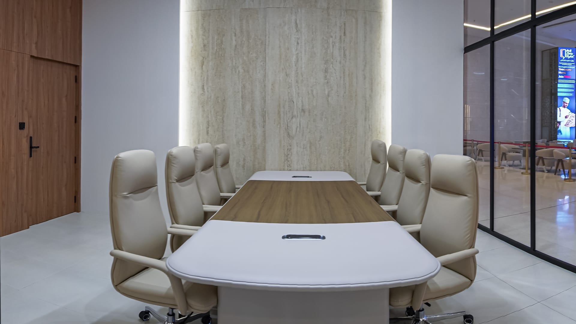 Meeting room with travertine accent wall at Tasees
